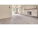 Bright living room with large windows, elegant lighting and a stylish fireplace at 1160 Johnson St, Lakewood, CO 80215