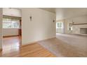 Spacious living room with a glimpse of the kitchen, featuring elegant lighting and neutral colors at 1160 Johnson St, Lakewood, CO 80215