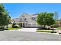 Two-story house with a three-car garage and mature trees at 4686 Longs Ct, Broomfield, CO 80023