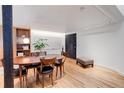 Bright dining room with wood floors, large table, and modern accents at 3377 Blake St # 205, Denver, CO 80205