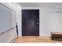Hallway featuring a unique chalkboard door and hardwood flooring at 3377 Blake St # 205, Denver, CO 80205