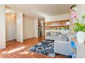 Open-concept living room with hardwood floors and a view of the kitchen at 1918 Depew St, Lakewood, CO 80214