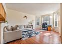 Bright and airy living room featuring hardwood floors, neutral walls, and large windows at 1918 Depew St, Lakewood, CO 80214