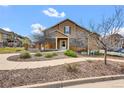 Inviting two-story home with meticulously maintained landscaping, complemented by a sunny sky at 4822 Pathfinder Ct, Castle Rock, CO 80108