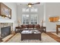 Bright living room featuring a fireplace, hardwood floors, large windows with shutters and vaulted ceiling at 4822 Pathfinder Ct, Castle Rock, CO 80108