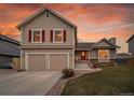 Inviting home with a two-car garage, complemented by a cozy front porch and landscaped front yard at 12028 W Aqueduct Dr, Littleton, CO 80127
