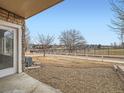 Backyard with gravel patio, view of golf course, and partial fence at 2833 W 119Th Ave # 15-102, Denver, CO 80234