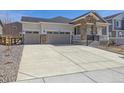 Long concrete driveway leading to a two-car garage at 4066 N Irvington St, Aurora, CO 80019