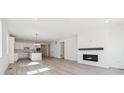 Spacious living room and kitchen area with an electric fireplace at 4066 N Irvington St, Aurora, CO 80019