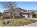Charming two-story home with a three car garage, brick accents and a well-manicured lawn at 518 Zircon Way, Superior, CO 80027