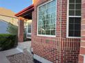 Close-up of brick exterior with large window and covered porch with stone steps at 518 Zircon Way, Superior, CO 80027