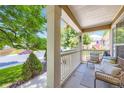 Inviting front porch featuring comfortable seating and a view of the street, perfect for relaxing at 9264 Fox Fire Ln, Highlands Ranch, CO 80129