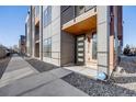 Stylish townhome exterior with modern design, featuring a private balcony and landscaped front entrance at 3011 W 53Rd Ave, Denver, CO 80221