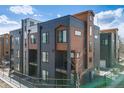 Modern townhome exterior showcasing its unique design and multiple levels with wood accents and balconies at 3011 W 53Rd Ave, Denver, CO 80221
