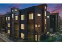 Modern townhome showcasing a stylish exterior with clean lines and a mix of dark gray and wood-tone siding at 3011 W 53Rd Ave, Denver, CO 80221