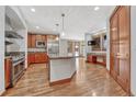 Spacious kitchen featuring island, stainless steel appliances, and hardwood floors at 9535 S Shadow Hill Cir, Lone Tree, CO 80124