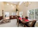Formal dining room featuring a high ceiling, chandelier, and lots of natural light at 9640 S Johnson St, Littleton, CO 80127