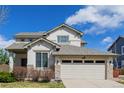 Charming two-story home with a well-manicured lawn and attached two-car garage at 9640 S Johnson St, Littleton, CO 80127