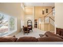 Spacious living room with staircase, tall windows, and an open floor plan at 9640 S Johnson St, Littleton, CO 80127