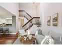 Open-concept living area with a wooden staircase, hardwood floors, and a modern aesthetic at 2891 W Long Dr # D, Littleton, CO 80120
