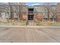 Front view of building, showing entrance and parking at 3656 S Depew St # 104, Denver, CO 80235