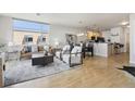 Cozy living room featuring modern decor with hardwood flooring flowing into an open kitchen at 3101 Blake St # 309, Denver, CO 80205