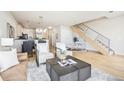 Bright living space features hardwood floors, comfortable seating, and an open staircase at 3101 Blake St # 309, Denver, CO 80205