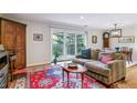 Charming living room featuring wood floors, a cozy couch, and sliding glass doors leading to a balcony at 460 S Marion Pkwy # 453, Denver, CO 80209