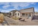 Spacious backyard featuring a fire pit area and meticulous landscaping at 9772 Taylor River Cir, Littleton, CO 80125