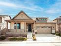 Inviting single-Gathering home showcasing a quaint front porch and attached two-car garage at 9772 Taylor River Cir, Littleton, CO 80125