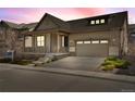Charming single-Gathering home boasting a welcoming front porch and attached two-car garage at 9772 Taylor River Cir, Littleton, CO 80125
