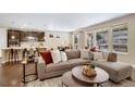 Bright and inviting living room featuring hardwood floors, neutral decor, and an open floor plan at 9772 Taylor River Cir, Littleton, CO 80125