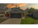Charming two-story home with a gray exterior, a well-manicured lawn, and a two-car garage with a concrete driveway at 2330 Redwood Ave, Lafayette, CO 80026