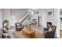 Bright living room with vaulted ceilings, a fireplace, lots of natural light, and modern gray furnishings at 2330 Redwood Ave, Lafayette, CO 80026