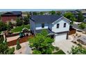 An aerial shot showcases the home with a backyard featuring a play set at 25097 E Lake Dr, Aurora, CO 80016