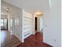 Inviting hallway featuring hardwood floors and built-in shelving for added storage and functionality at 246 Rockview Dr, Superior, CO 80027