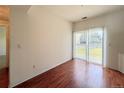 Bright living room featuring wood floors and sliding glass doors to outdoor patio at 246 Rockview Dr, Superior, CO 80027