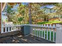 The backyard view shows a deck area with a small fence at 703 S Depew St, Lakewood, CO 80226