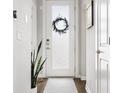Bright entryway with a frosted glass door, modern accents, and minimalist decor at 6777 Mariposa St, Denver, CO 80221