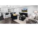 Bright, open-concept living space showcases updated flooring, a modern entertainment center, and eat-in kitchen at 412 Gemini Ct, Lone Tree, CO 80124