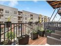 Outdoor balcony with planters, modern railing and views of the neighborhood at 2960 Inca St # 317, Denver, CO 80202