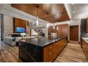 Gourmet kitchen with a large island and open floor plan into living area at 5140 S Kearney Ct, Greenwood Village, CO 80111