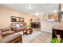 Spacious living room with brown leather furniture and hardwood floors at 833 E 98Th Ave # 204, Thornton, CO 80229
