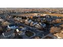 Panoramic aerial view of a residential neighborhood with a nearby school at 11413 Oswego St, Commerce City, CO 80640