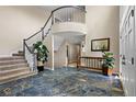 Elegant foyer with marble floors, high ceilings, and a beautiful staircase with a rounded balcony at 19665 E Ida Pl, Aurora, CO 80015