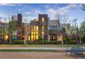 Contemporary townhomes showcase a modern design and inviting curb appeal, framed by manicured greenery and a park bench at 8071 E 29Th Ave, Denver, CO 80238