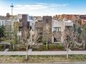 Elevated angle shows modern townhomes with architectural detail and manicured landscapes at 8071 E 29Th Ave, Denver, CO 80238