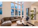 Bright living room featuring floor-to-ceiling windows, modern decor, and hardwood floors at 8071 E 29Th Ave, Denver, CO 80238