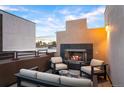 Inviting rooftop deck with a cozy fireplace, comfortable seating, and a serene ambiance for relaxing evenings at 8071 E 29Th Ave, Denver, CO 80238