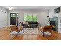 Spacious living room features a fireplace, large windows, and comfortable seating at 2485 S Fillmore St, Denver, CO 80210